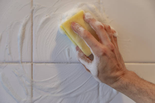 istock Hand cleaning white tiles with  a scourer 1465232440