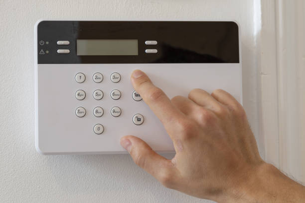 istock Man setting up an alarm in a flat 1465232445