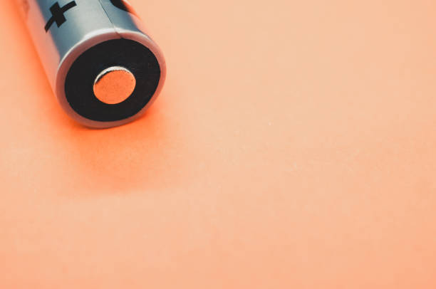 istock Closeup shot of a battery on a light orange background 1465235794