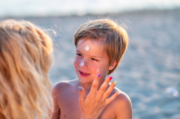 istock Mom smears sunscreen on the boy's face. 1465236755