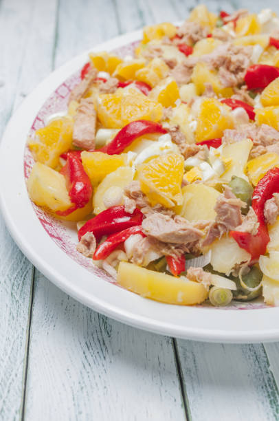 istock Orange salad with onion, pepper, potatoes a boiled eggs 1465236868