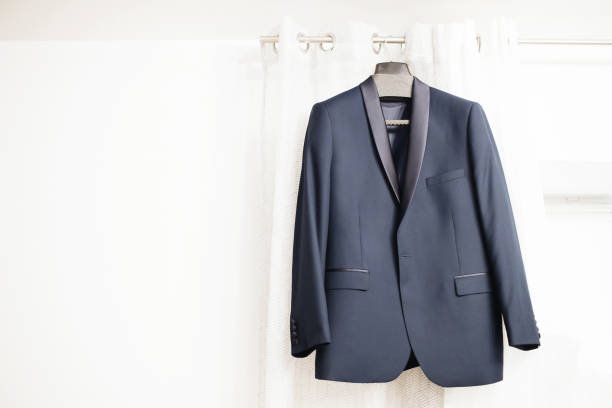 istock Blue suit hanging. Wedding preparation fashion background. 1465237895
