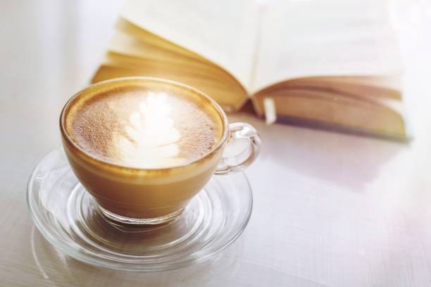 istock hot espresso coffee and opened book preparing for breakfast and learning on table 1465238499