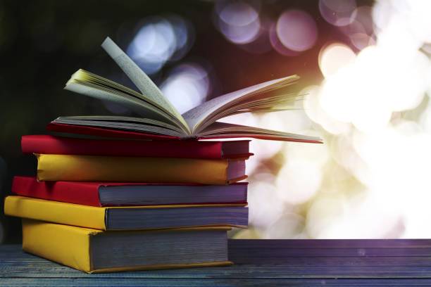 istock book on wood table with bokeh background 1465239995