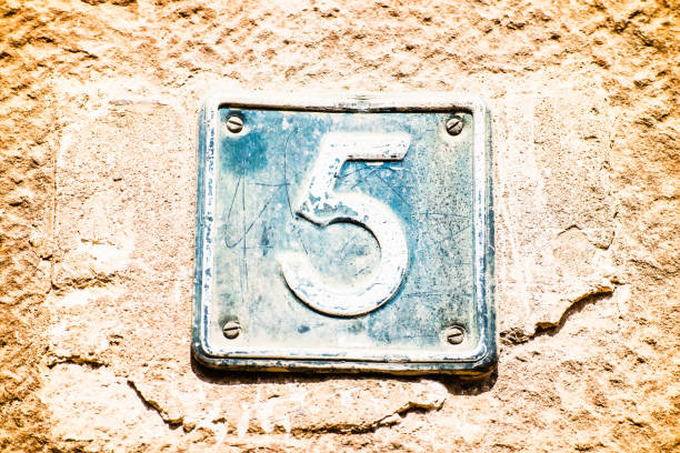istock Close up of plate with number five on old brown wall 1465242144