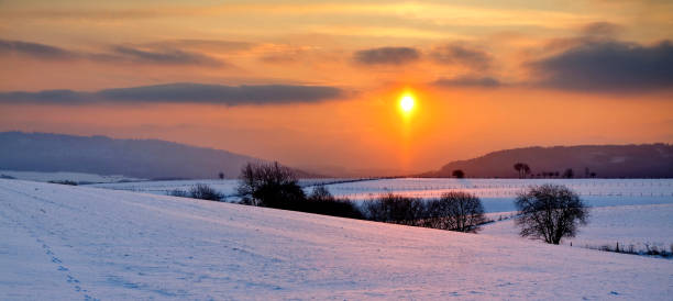 istock Beautiful view of the snow-covered fields captured at sunset 1465242917