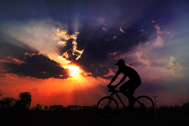 istock silhouette man ride bicycle in sunset 1465243270