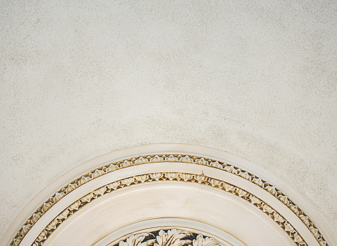 A closeup shot of plaster decorations on a white wall