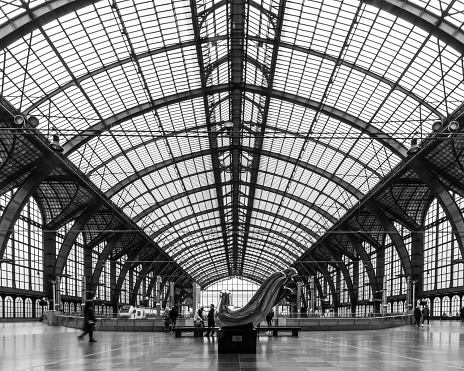 Antwerp, Belgium - June 2019: Internal facade in the Interior of Antwerp Central Train station with sun shining through the glass windows