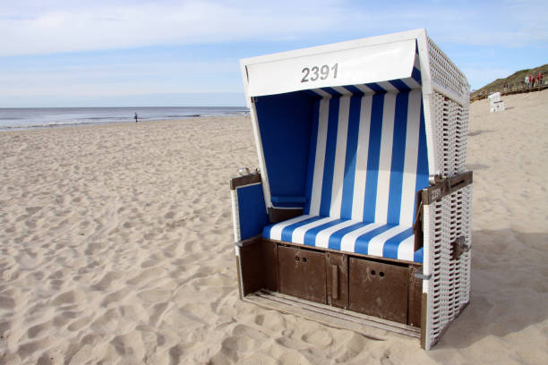 istock Blue beach chair on a sandy beach under a blue cloudy sky in Sylt, Germany 1465247040