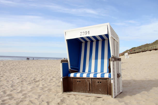 istock Blue beach chair on a sandy beach under a blue cloudy sky in Sylt, Germany 1465247041