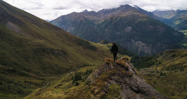 istock Woman standing on a mountain ridge 02 1465247945