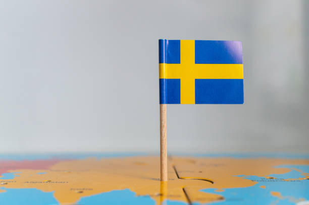 istock Small flag of Sweden on a wooden stick fixed on the globe 1465249265