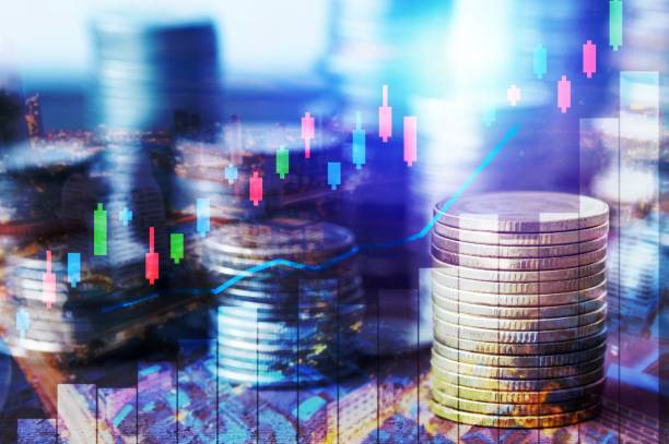 Finance, profit, capital banking and investment concept, Double exporsure stacked of coins and night city with graph stock photo