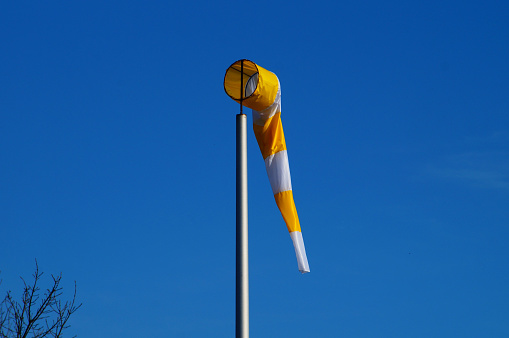 Symbolically, windsocks at the former Frankfurt-Bonames airfield are a reminder of flight operations. Here a yellow-orange one.