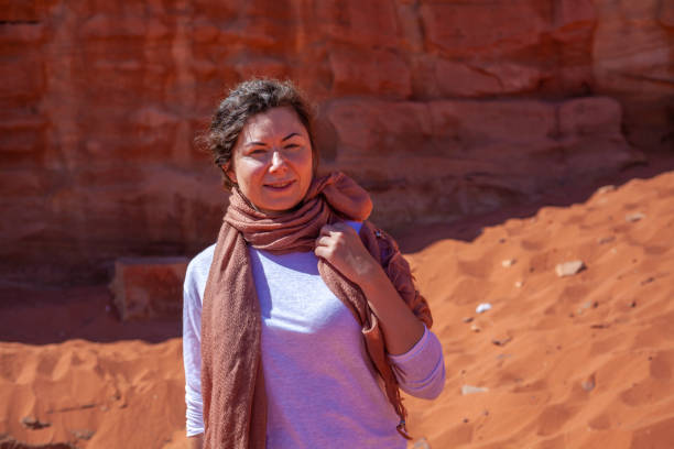 istock Beautiful caucasian female posing near red sandstone cliffs on a sunny day 1465254152