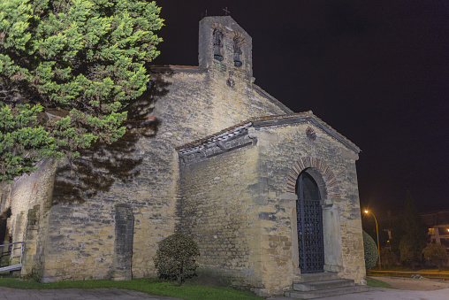 The San Julian de los Prados surrounded by lights at night in Spain