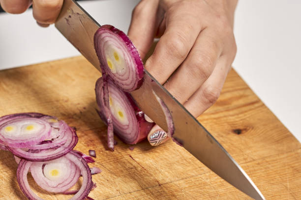 istock Person cutting onions on a chopping board 1465256100