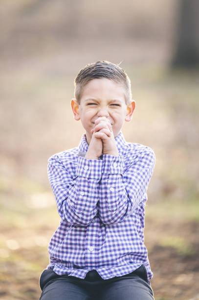 istock Vertical shot of a little Christian boy praying 1465257580