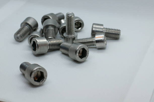 istock Closeup shot of some screws on a white surface 1465258291