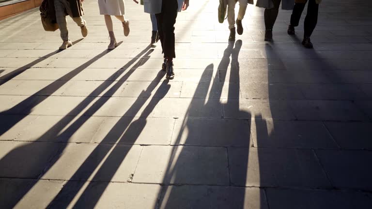 Silhouette of a group of unrecognizable business people talking outdoors in the city street.