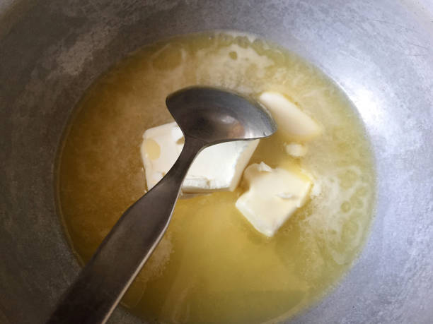 istock Butter margarine melting in a cooking pan with spoon 1465262466