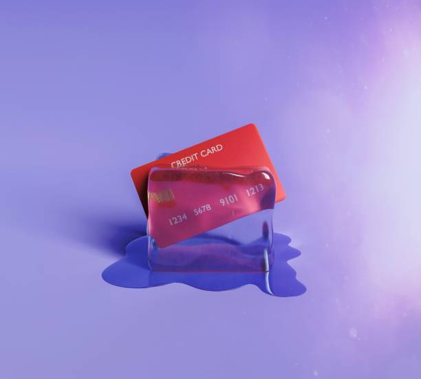credit card in an ice cube stock photo