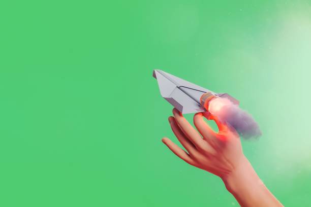 istock hand launching a propelled paper airplane 1465263820