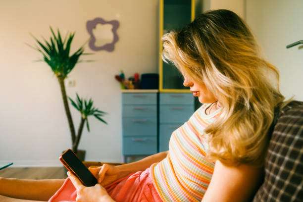 istock Young attractive caucasian woman using mobile phone at home. 1465264191