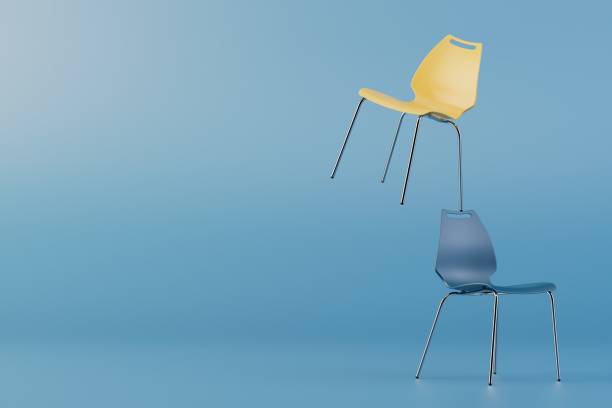 istock blue and yellow plastic chairs standing on top of each other on a blue background. copy paste. 3D render 1465265284