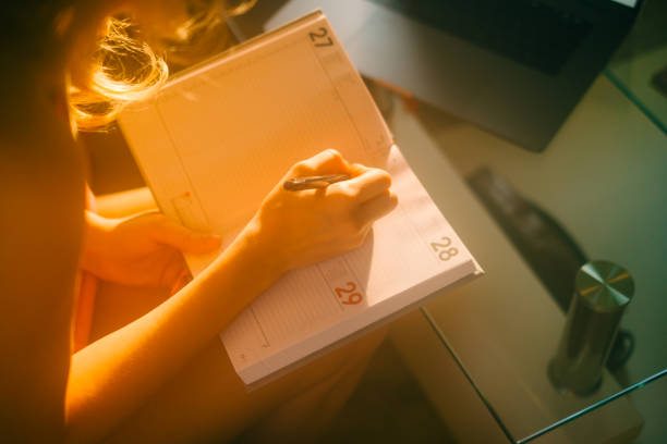 istock Caucasian woman making notes at home office. 1465266905