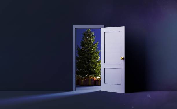 christmas tree behind a door stock photo