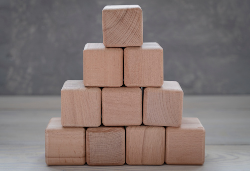 Blank wood cube block on top pyramid