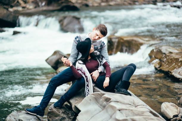 istock guy and girl along a mountain river 1465274506