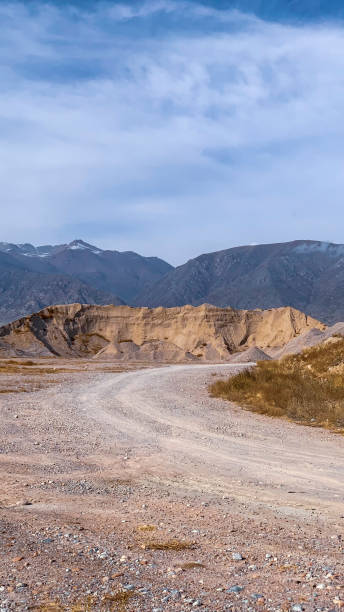 istock Mountainscape with a country road in a sunny day 1465274573
