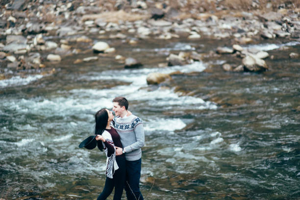 istock guy and girl along a mountain river 1465275257