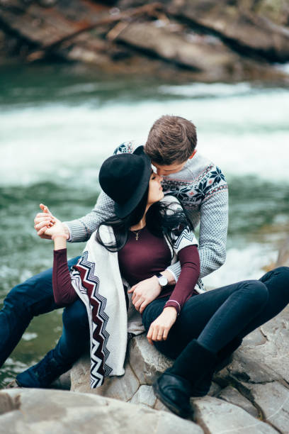 istock guy and girl along a mountain river 1465275296
