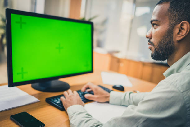 istock Businessman working on green screen desktop 1465276379