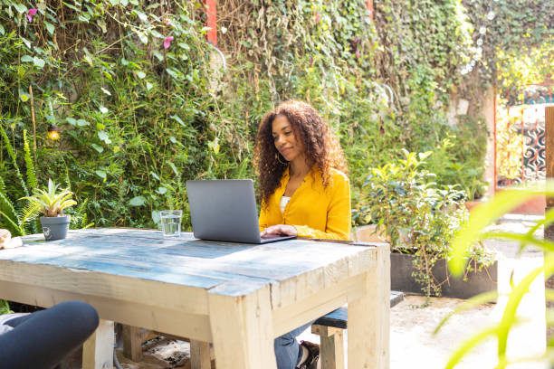 istock Brazilian woman using laptop at garden 1465276404