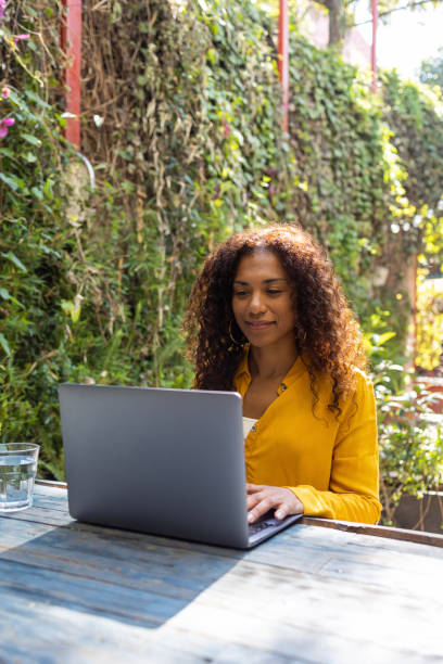 istock Brazilian woman using laptop at garden 1465276454