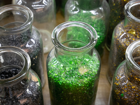A glass jar containing multiple tadpoles