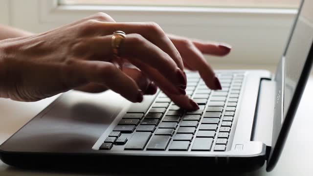 Female hands of business woman professional user worker using typing on laptop.