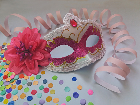 Carnival is recognized as the biggest Brazilian party. Almost everyone takes to the streets to celebrate using costumes or props.\nThe photo shows three accessories used in carnival in Brazil: mask, serpentine and confetti.
