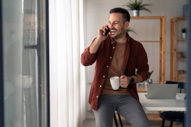 istock Attractive man enjoying a pleasant conversation on smart phone 1465289675