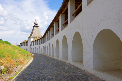 Astrakhan, Russia. View of the old tower with a wooden roof and a long white wall in the Astrakhan Kremlin.