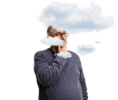 Mature man holding his chin and thinking with clouds around his head isolated on white background