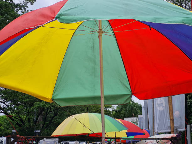istock Multicolored the umbrella for a colorful background. 1465298181