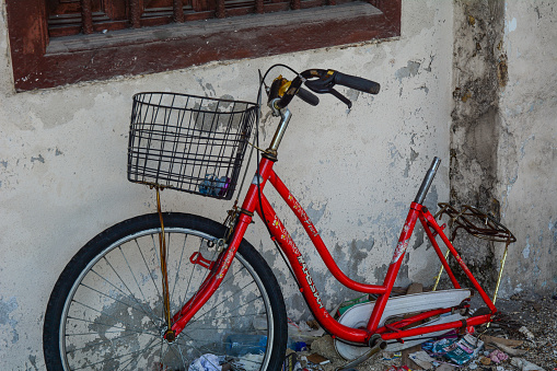 George Town, Malaysia - Mar 10, 2016. Old red bicycle in George Town, Malaysia. George Town is one of the most popular destinations in Malaysia.