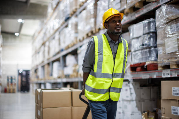 istock Portrait of smiling warehouse worker unloading pallet shipment goods 1465302727