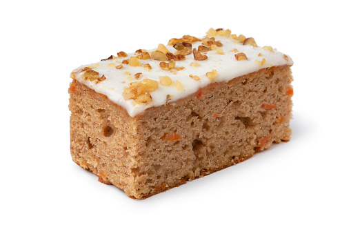 Piece of homemade carrot cake isolated on white background close up